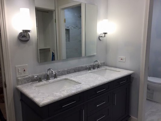 Full vanity installation with mirror and sconces