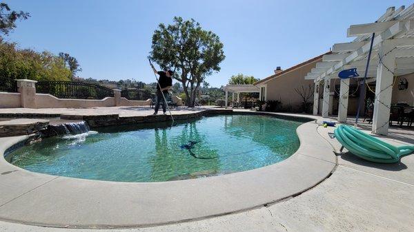 Josh, the owner, cleaning a pool in Whittier