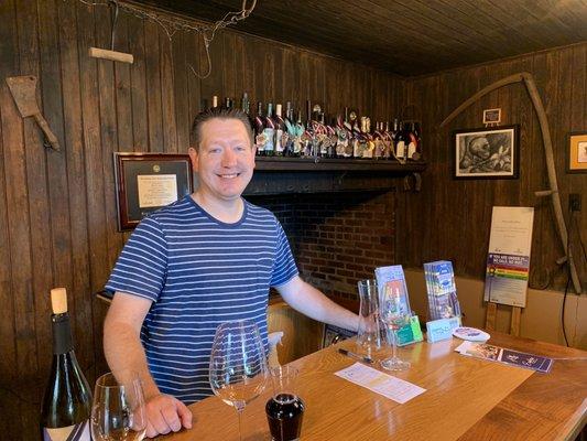 Dan and his award-winning wines on the wall.