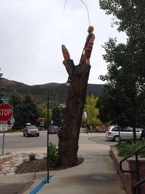 Here, across the street the town has a great little carving of a fly fisherman in the top of an old dead tree.  Fun little city!