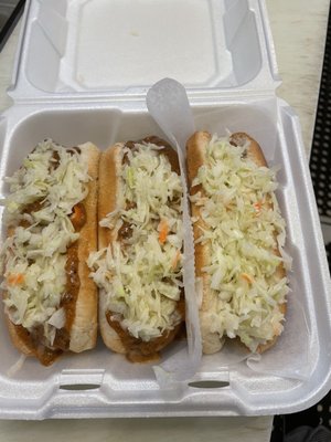 2 hot dogs all the way with coleslaw (left)  1 with coleslaw (right)