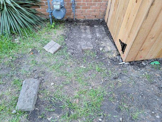 This is the mess that was left outside the fence door.  You can see a capped sprinkler that they broke when digging the post holes.