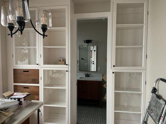 Sitting room cabinets repurposing windows from the original 1945 cabin.