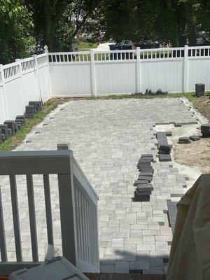 Backyard with pavers being laid.