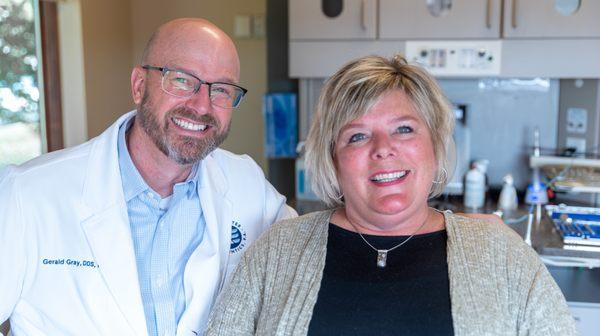 Dr. Gray smiling with patient during their visit at Rochester Endodontics