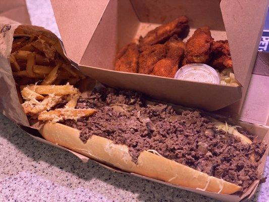 Another angle of steak cheese, fries, and wings!