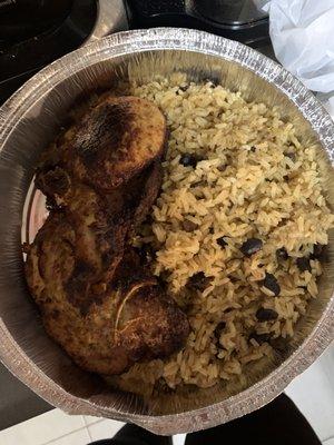 Yellow rice with black beans sweet plantains fried pork chops..