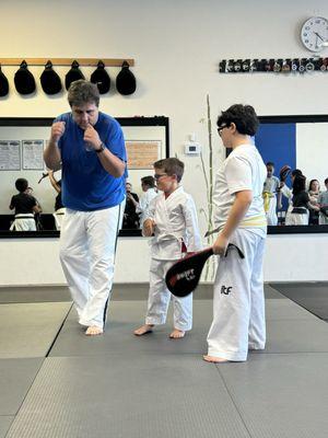 Showing correct technique to my son (the little guy )