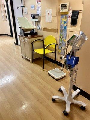 Nurses' station for weighing, measuring height, taking blood pressure, etc.