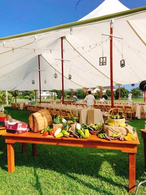 45' x 84' Sheer sailcloth tent for an annual Island to Table fundraiser for Home Grown Change. Complete with Farm Tables and rustic decor.