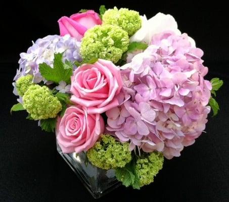 Spring arrangement with roses, hydrangeas and other spring time flower