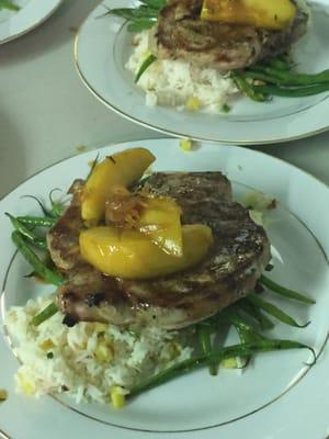 Grilled pork chops with grilled pineapple jasmine rice and French green beans with garlic butter and toasted almonds.