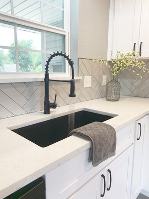 Under mount sink, with industrial looking faucet and luxury quartz. New double pane vinyl windows.