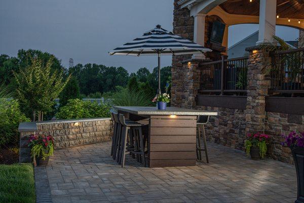 Custom outdoor table with bluestone top. hardscape retaining wall & patio, plus landscape design