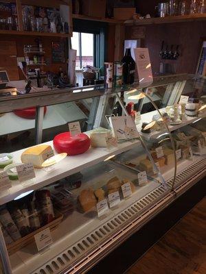 Cheese fridge w/ a few dip selections and small cured meats section