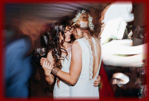 Happy Newlywed Lesbian couple having a wonderful time dancing their "First Dance" at their wedding reception