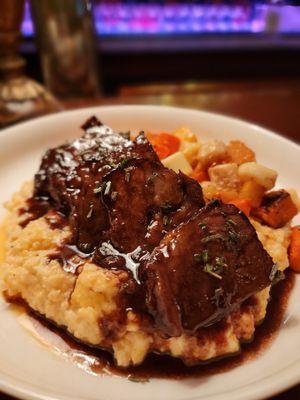 Braised short rib with creamy polenta and roasted root vegetables.