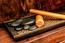 Sticks and stones massage for therapeutic relief.