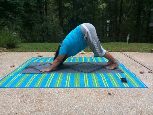 Private client lengthening the spine in Downward facing dog.