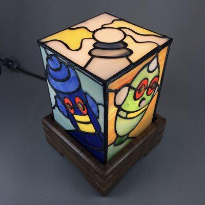 This is a whimsical stained glass robot lamp. There are four different heads on the lamp. The perfect gift for the geek in your life.