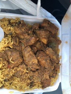 Stewed pork ribs over rice with pigeon peas