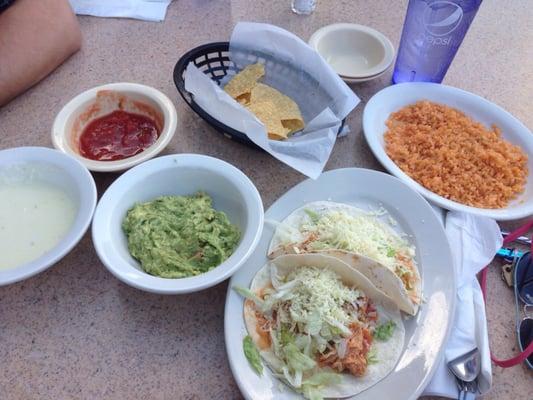 Chicken tacos, side of rice, large guacamole and cheese, regular free chips and salsa.