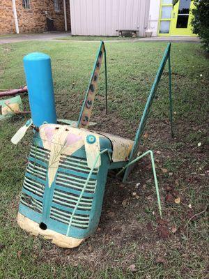 8/1/19. Thursday afternoon. Old tractor grill, other parts artfully repurposed into a grasshopper on the lawn here.