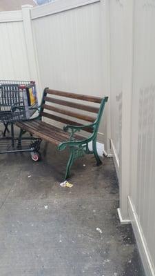 Filthy employee smoking area next to outdoor cafe seating.