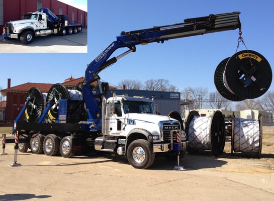 Crane Truck moving Reels of Cable