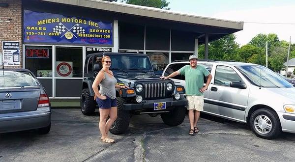 Eric and Emily with their Jeep Wrangler.