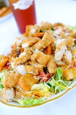 Our House Salad topped with Fried Chicken.