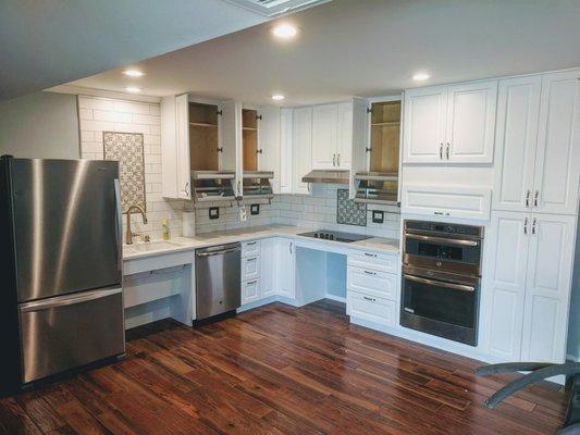 Accessible kitchen remodel.  Roll under sink. Lowered ovens. Roll under cook top and pull down upper cabinet shelves.