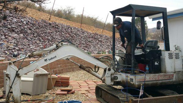 Scott worked hard even with the backhoe to not touch the retaining wall.