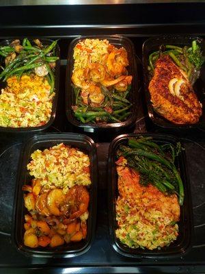 The meal prep can be customized based on your food likes and dietary needs. Pictured are salmon, shrimp, and baked chicken meals.