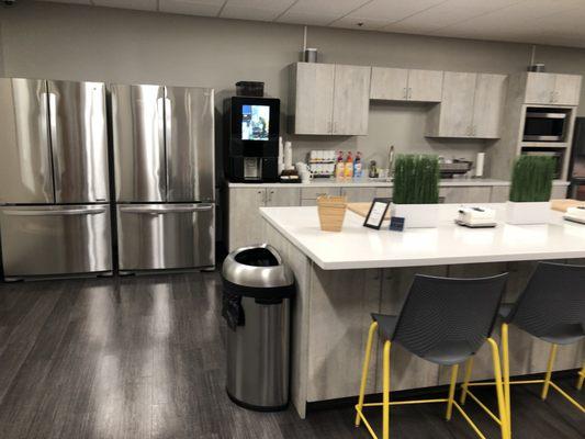 Fridges, Starbucks coffee machine and accessories, microwaves, cabinets, etc. Such a nice kitchen!