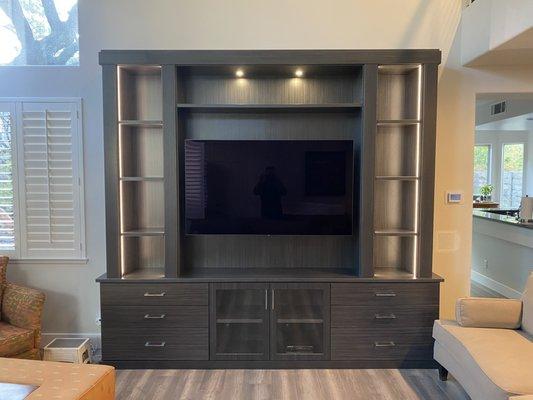 Custom built in unit with an articulating 65" LG OLED.