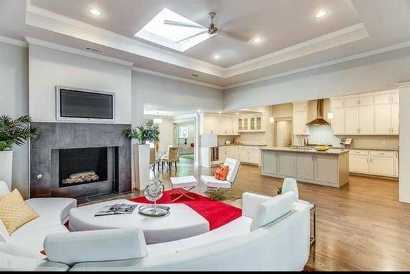 New open floor plan with raised ceiling and skylight. Refacing of fireplace and installed gas logs.