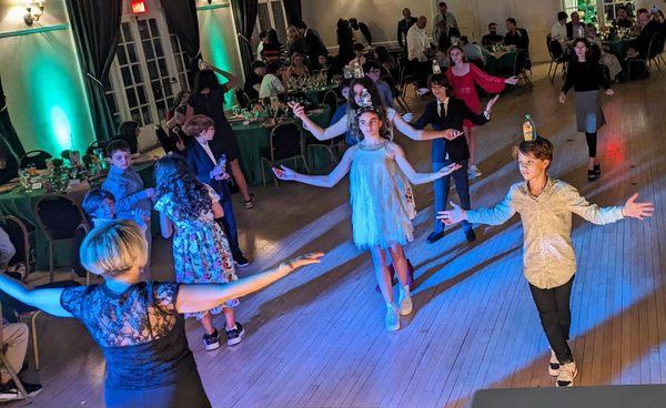 Natasha leading bar mitzvah guests in the Bottle Dance Contest