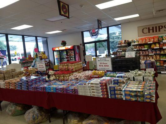 Well stocked with a variety packaged treats including donuts, snack cakes, chips and beverages.