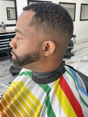 Mid skin fade with beard trimming and shaping.