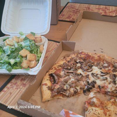 Pizza with mushrooma and sausage. Ceasar salad.