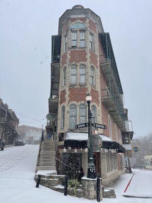 Eureka Charcuterie and the Flat Iron building in the snow.