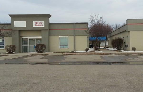 The entrance is under the blue. awning.