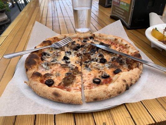 Sausage, mushroom, and olive pizza. Mozzarella counts as one topping.