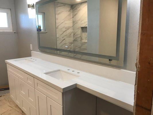 Here we set new countertops as well as the shower enclosure you can see in the background.