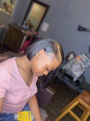 A traditional quickweave bob. Hair is braided, protected with products and a cap. Pack hair or bundles are glued in, then cut and styled.