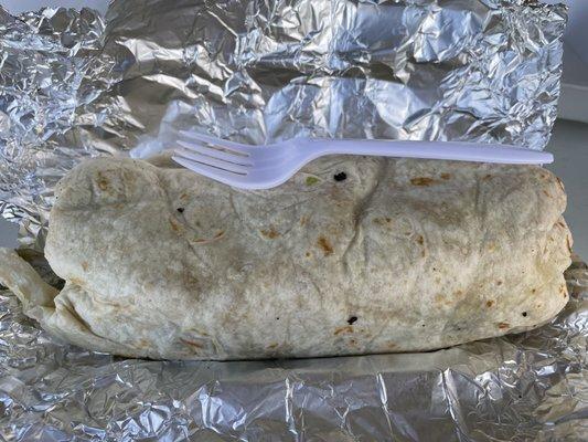 Cachete Santa Burrito. Fork for scale. They say this is enough for 2. It is no joke! Plus it is super messy, which is a plus to me. 10/10!