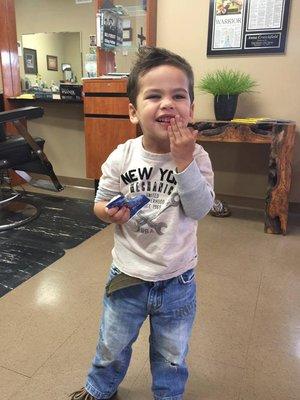 Handsome little client with a happy visit to the Furman Barber Shop