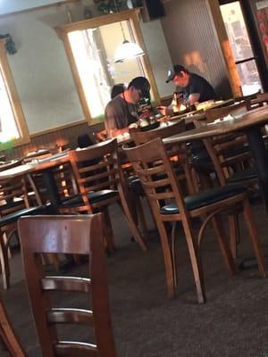 Pizza Hut employees enjoying some R&R while no one else is in the restaurant