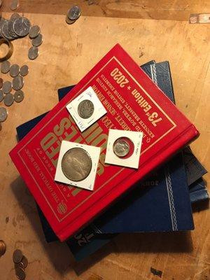 A book some folders and coins I got while at the store